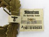 a gold colored ribbon with a label on it