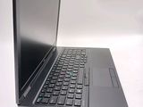 a laptop computer sitting on a table with a keyboard