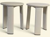 two stools sitting side by side on a white surface