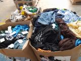 many boxes of clothes that are sitting on the floor