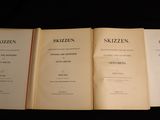three open books sitting on top of each other on a table