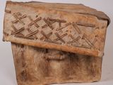 an old wooden box sitting on top of a white surface
