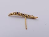a close up of a gold hair pin with blue stones on it