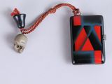 a small black and red lighter with a skull on it
