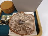 a brown and white checkered pillow and a brown and white box on a white table