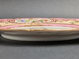 an image of a pink and gold bowl on a gray surface