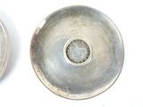 two silver plates that are sitting next to each other