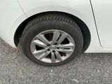 a close up of a tire on a white car