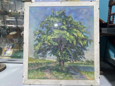 a painting of a tree on display in a glass case