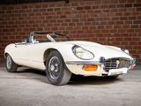 an image of a white sports car parked in front of a brick wall