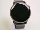 a smart watch sitting on top of a clear stand