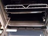 an open oven with two racks in the middle of it