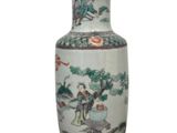 a vase with a painting on it sitting on a table