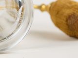 a close up of a glass object with a wooden handle