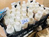 many bottles of white paint in a crate on the floor