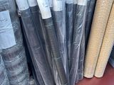 many rolls of fabric on the shelf in the store