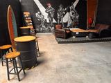 a room that has a lot of furniture and a surfboard on the wall