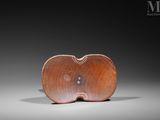 an image of a wooden apple shaped object on a gray surface