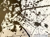 a black and white picture of an umbrella with splats on it