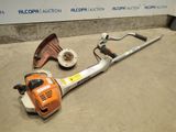 an image of a chainsaw and other tools sitting on the ground