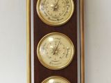 three clocks mounted on the wall of a room