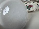 many plates and bowls sitting on a table