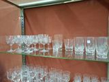 many glasses on a glass shelf in a room