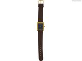 une photo d'une montre avec un bracelet en cuir marron