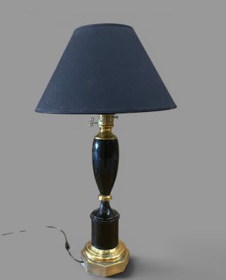 an image of a black lamp with a gold base and a blue shade