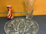 two vases and a plate sitting on a table