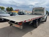 a picture of a flatbed truck parked in a parking lot