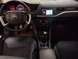 the interior of a car with a steering wheel and dashboard controls