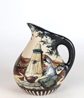 a vase with a painting of a man sitting on a bench