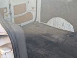 a white van with the door open in the back of the van