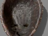 a close up of a metal object on a gray surface