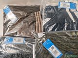 several bags of clothing are sitting on a table with tags on them