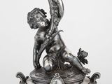 un plat ancien en argent orné d'une statuette représentant une femme tenant une bougie