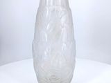 a glass vase sitting on a table with a white background