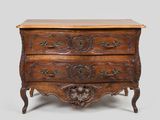 an old wooden chest of drawers with carvings on the drawers