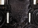 a close up of a metal cross with a clock on it