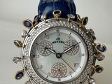 a close up of a watch on a white surface with a blue strap