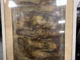 painting of a landscape in a frame on a shelf in a room