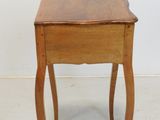 a small wooden table with a drawer on it