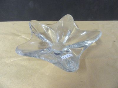 a clear glass flower shaped object on a table