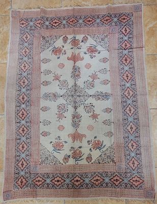 a rug on a tiled floor with a flower design on it
