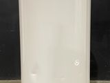 an image of a white water heater sitting on top of a cement floor