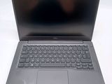 an open laptop computer sitting on top of a white table