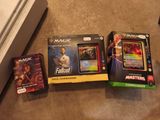 three magic the gathering cards are sitting on the floor next to each other