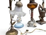 a lot of antique lamps that are sitting on a table