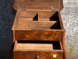 a small wooden table with two drawers on it